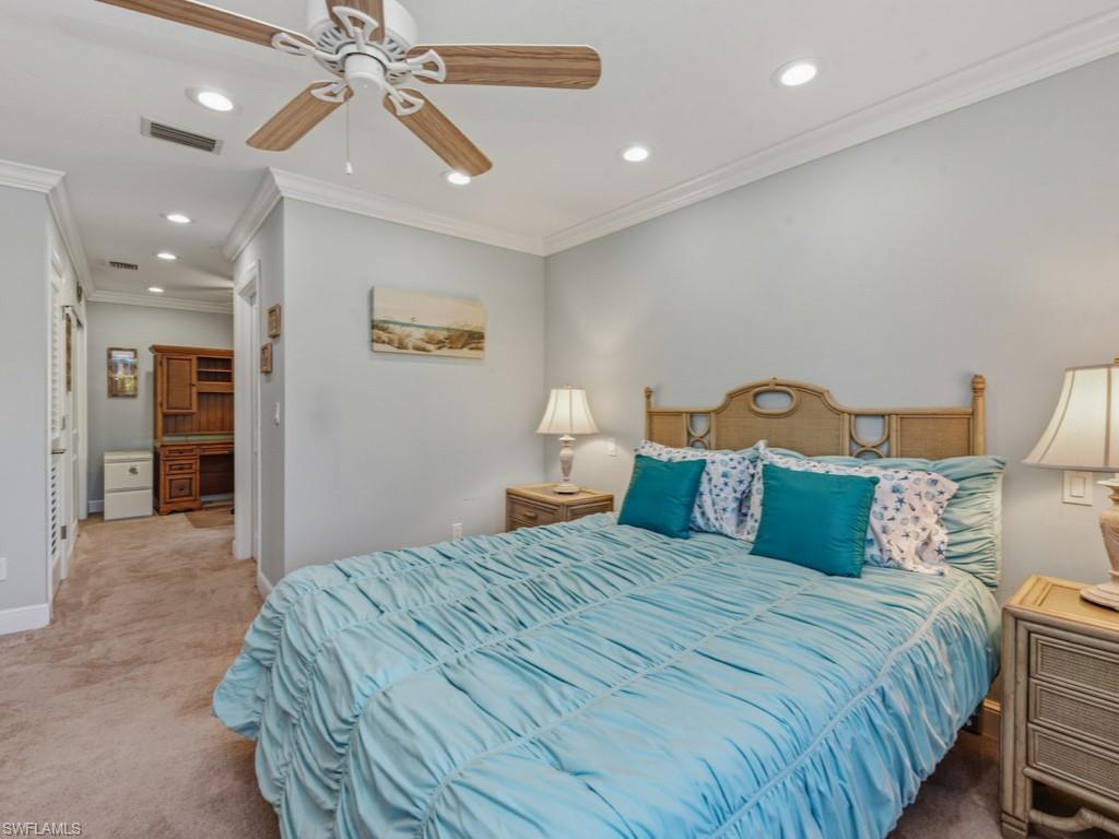 1081 Ruppert Road Marco Island, FL 34145 - Photo 18 of 39 a bedroom with a bed and a chandelier