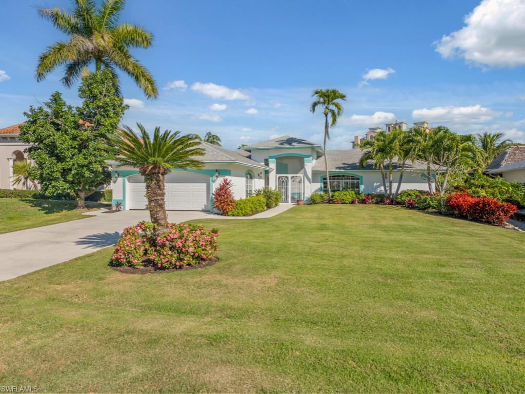 1081 Ruppert Road Marco Island, FL 34145 - Photo 2 of 39 a view of a garden with a building in the background