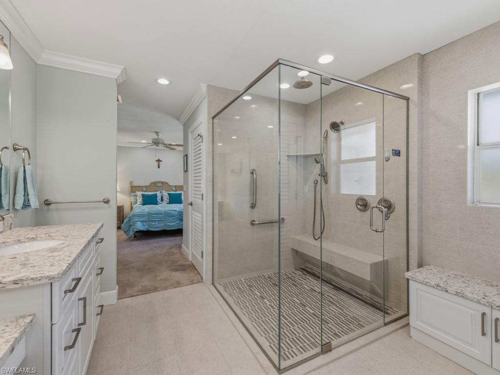 1081 Ruppert Road Marco Island, FL 34145 - Photo 21 of 39 a bathroom with a granite countertop sink mirror bathtub and shower