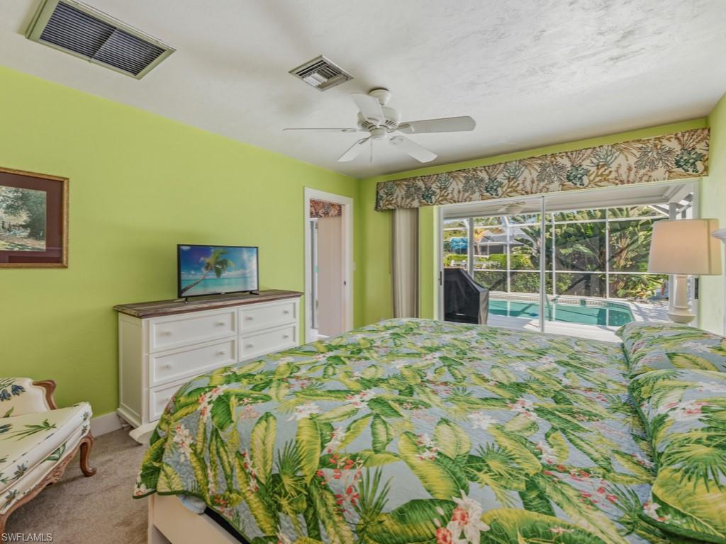 1081 Ruppert Road Marco Island, FL 34145 - Photo 22 of 39 a bedroom with a bed and a large window