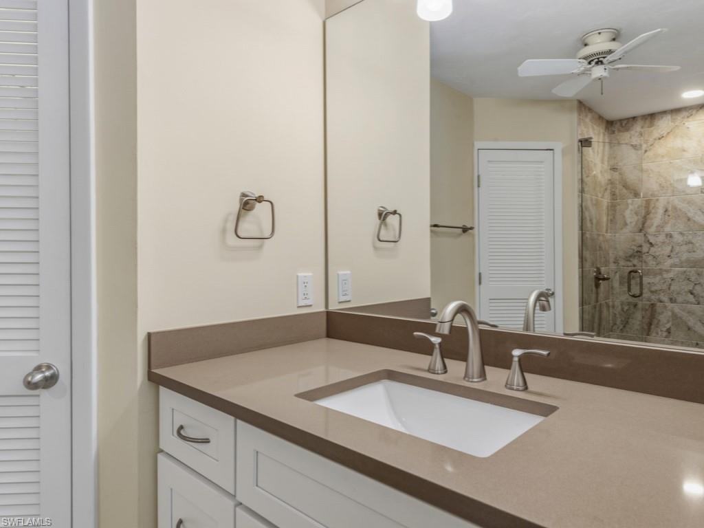 1081 Ruppert Road Marco Island, FL 34145 - Photo 23 of 39 a bathroom with a granite countertop sink and a mirror