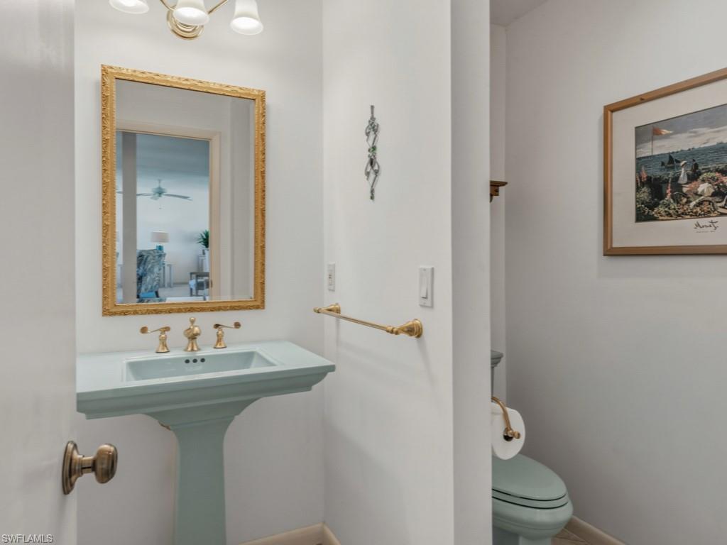 1081 Ruppert Road Marco Island, FL 34145 - Photo 8 of 39 a bathroom with a toilet sink and mirror