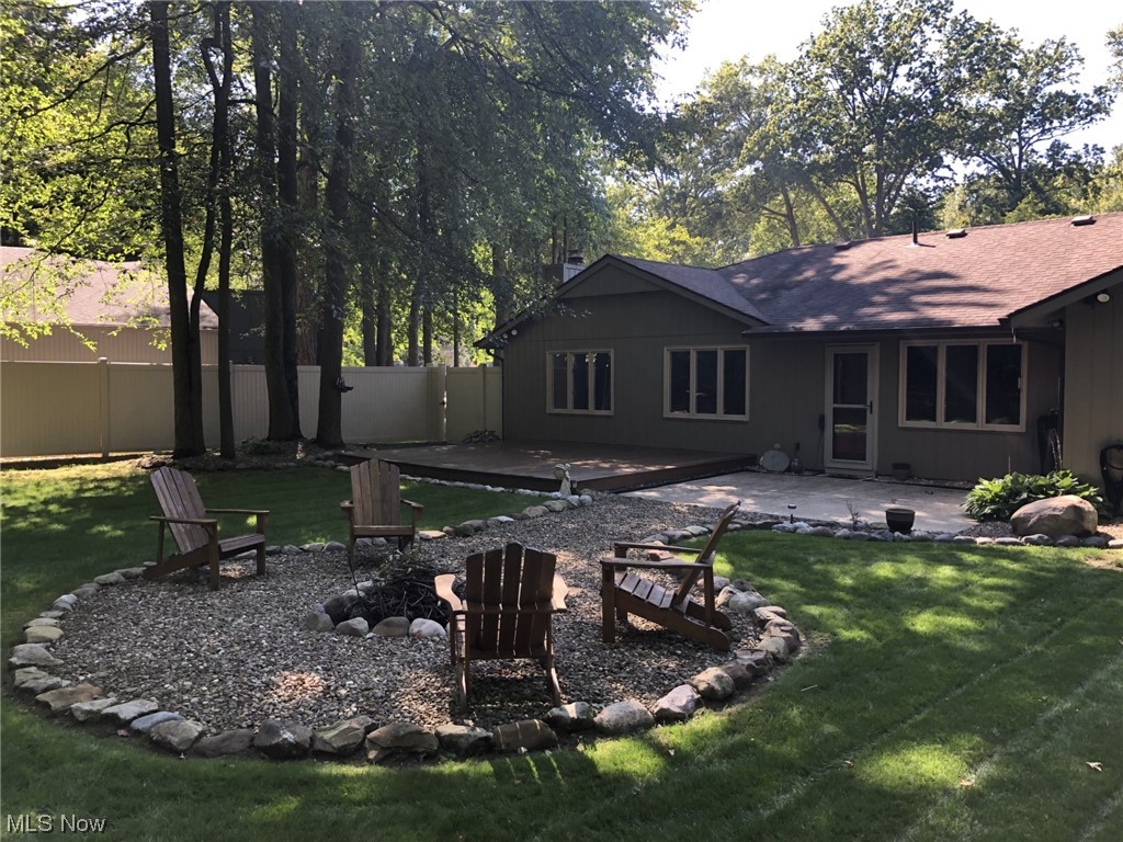 4931 North Barton Road North Ridgeville, OH 44039 - Photo 2 of 27 The backyard offers a deck, patio, and walkway to the fire pit.