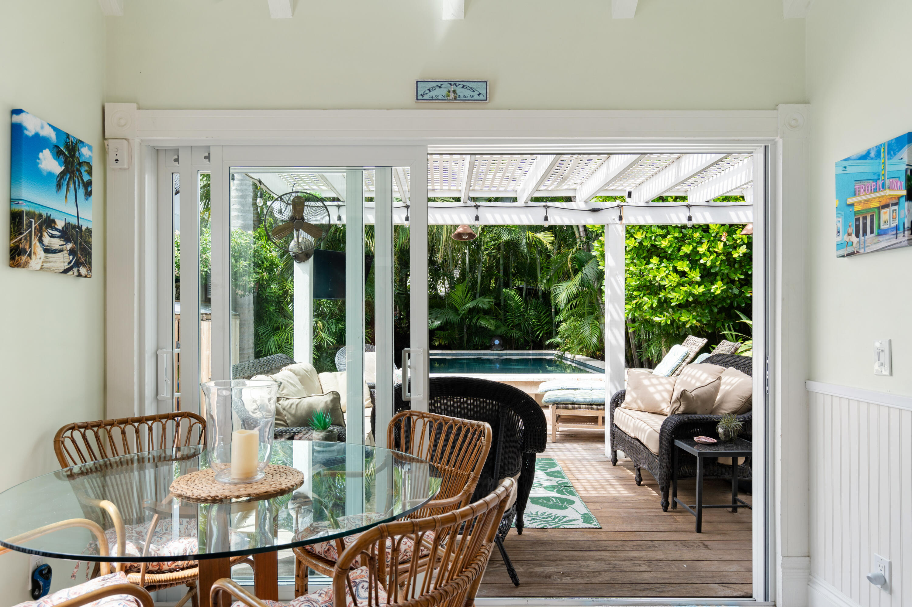 923 Eaton Street Key West, FL 33040 - Photo 17 of 42 a dining room with furniture a chandelier and wooden floor