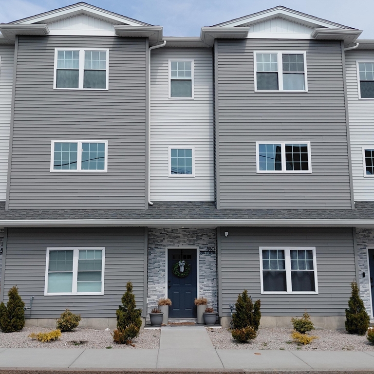 550 Spring Street, Unit 2 Fall River, MA 02721 - Photo 2 of 13 a front view of a house with a yard