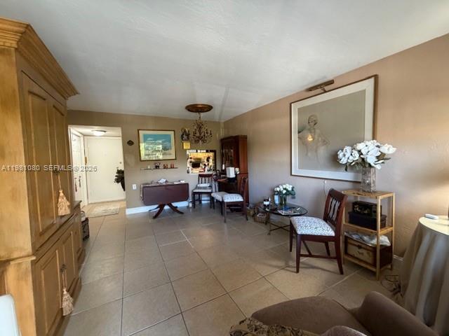 7403 Southwest 82nd Street, Unit 212N Miami, FL 33143 - Photo 3 of 10 a living room with furniture and a chandelier