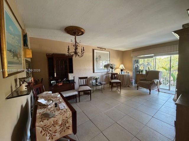 7403 Southwest 82nd Street, Unit 212N Miami, FL 33143 - Photo 4 of 10 a living room with furniture and a chandelier