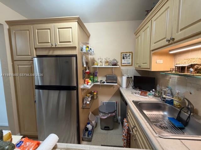 7403 Southwest 82nd Street, Unit 212N Miami, FL 33143 - Photo 5 of 10 a room with a refrigerator and a sink