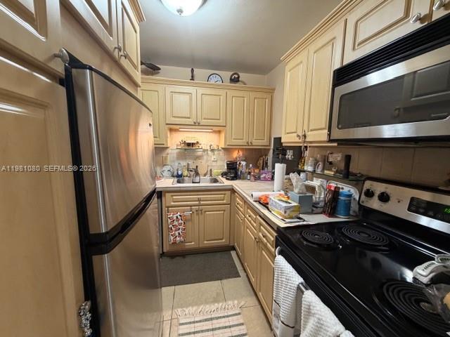 7403 Southwest 82nd Street, Unit 212N Miami, FL 33143 - Photo 6 of 10 a kitchen with stainless steel appliances granite countertop a refrigerator stove and sink