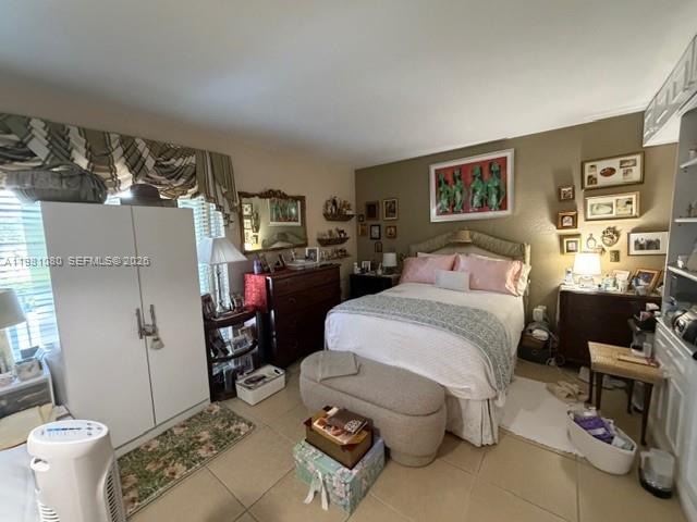 7403 Southwest 82nd Street, Unit 212N Miami, FL 33143 - Photo 10 of 10 a bedroom with a bed and a couch