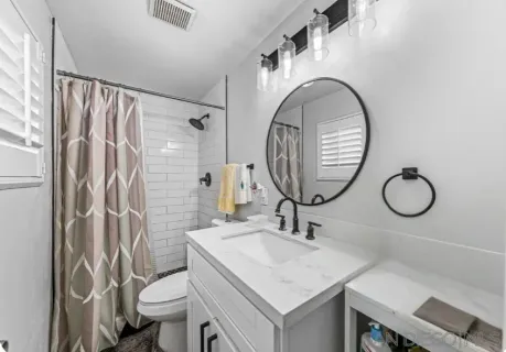 a bathroom with a sink toilet and shower