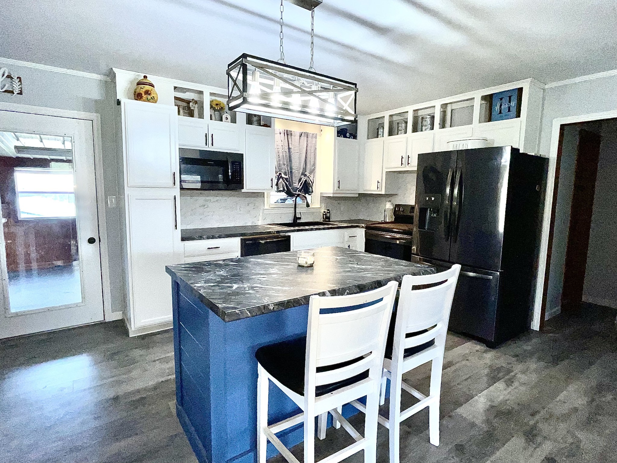 219 John Fuson Road Smithville, TN 37166 - Photo 13 of 84 a kitchen with stainless steel appliances granite countertop a kitchen island a stove a refrigerator a sink a dining table and chairs