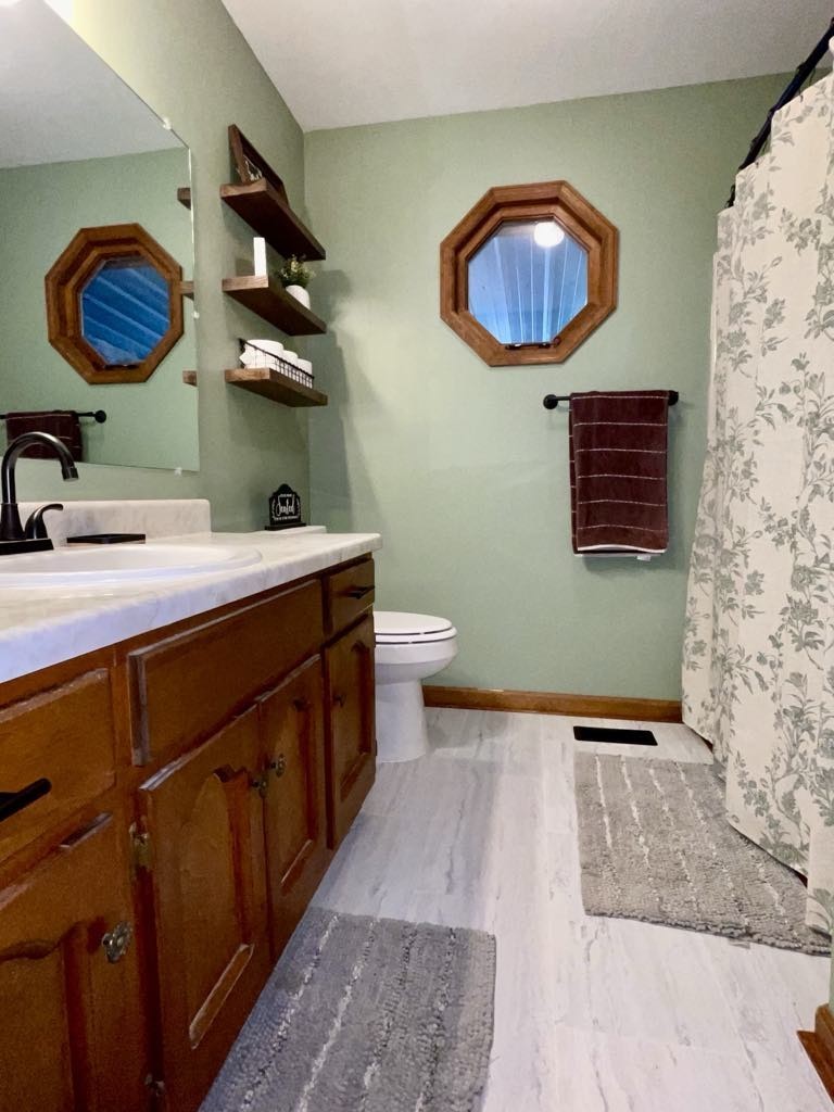 219 John Fuson Road Smithville, TN 37166 - Photo 29 of 84 a bathroom with a sink a toilet and mirror