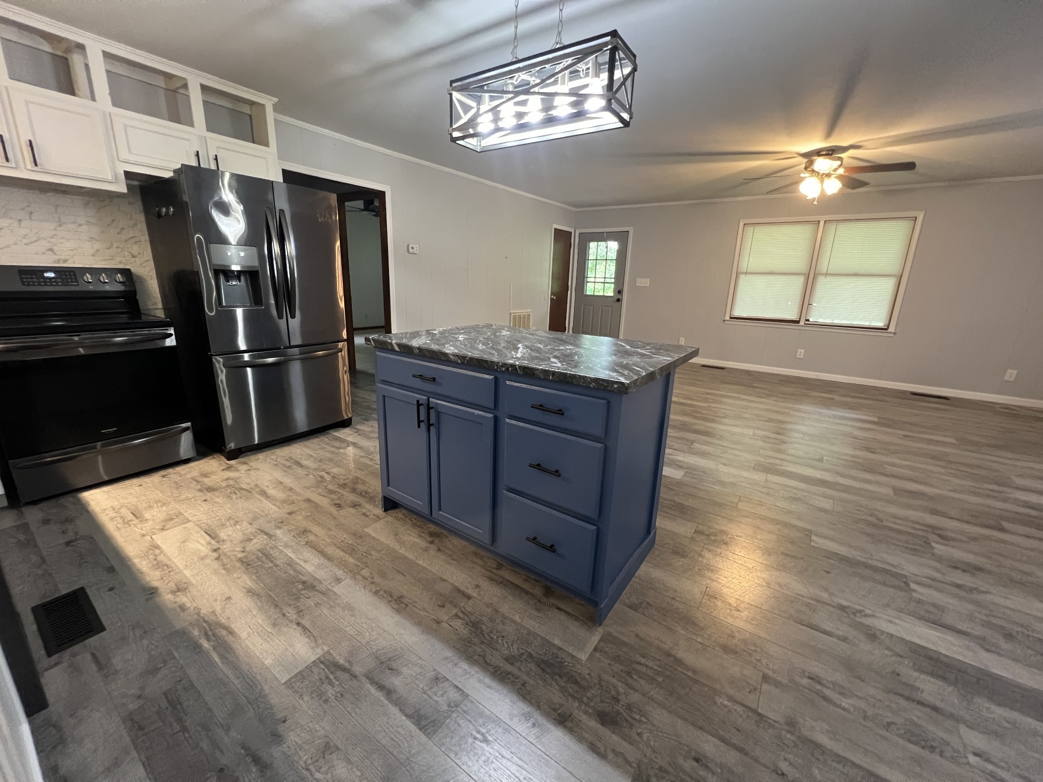 219 John Fuson Road Smithville, TN 37166 - Photo 64 of 84 a kitchen with stainless steel appliances granite countertop a refrigerator a sink dishwasher and wooden cabinets with wooden floor