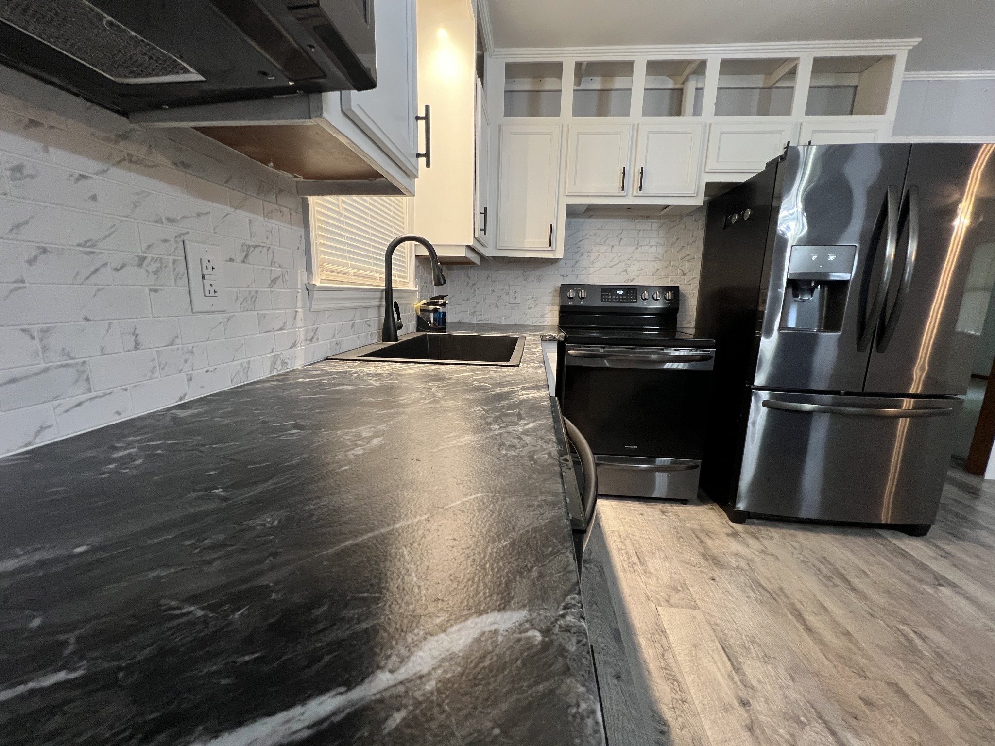219 John Fuson Road Smithville, TN 37166 - Photo 66 of 84 a kitchen with granite countertop a stove and a refrigerator