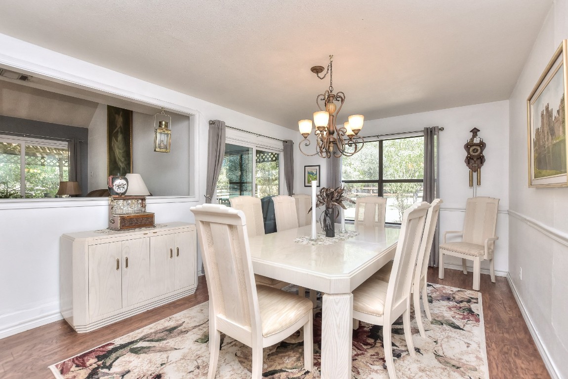 6724 Outer Avenue Leander, TX 78641 - Photo 12 of 40 a dining room with furniture a chandelier and wooden floor