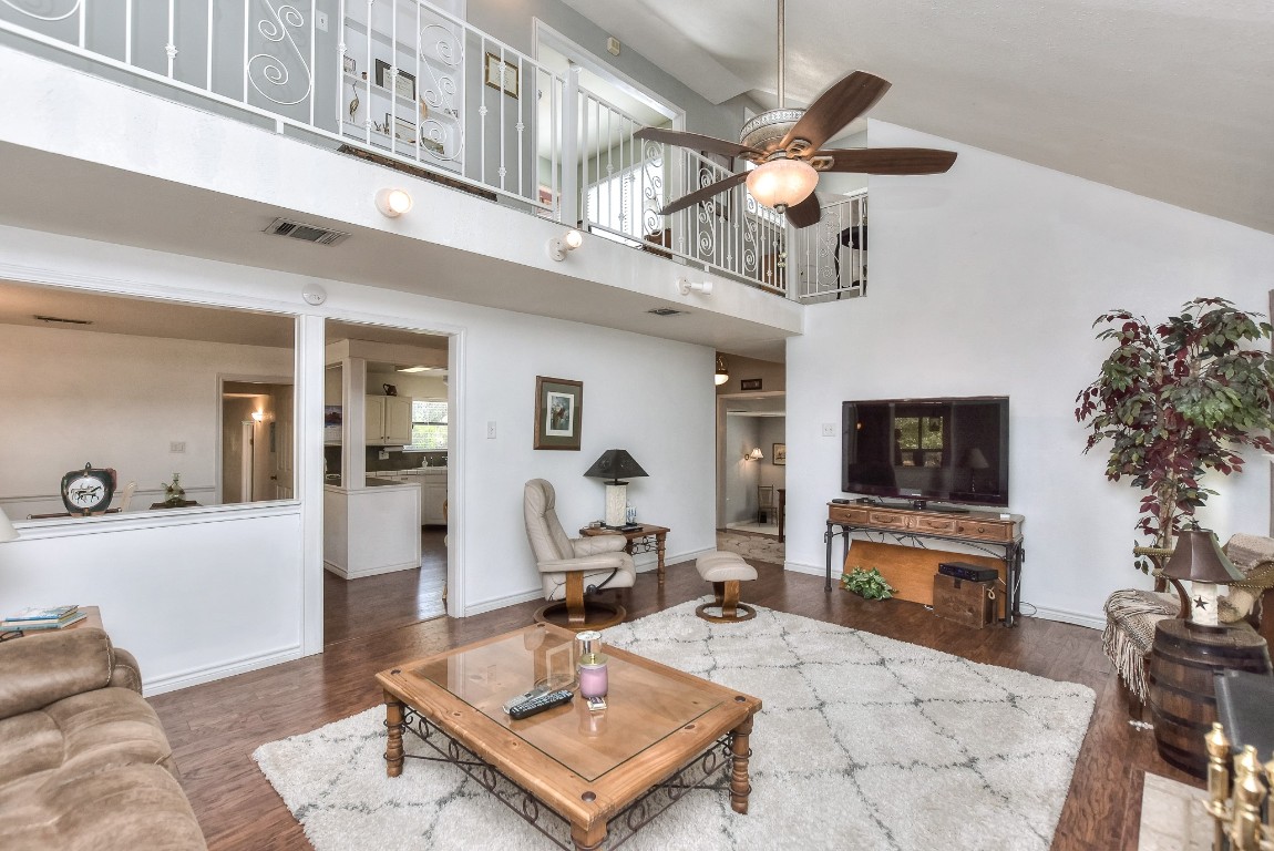 6724 Outer Avenue Leander, TX 78641 - Photo 17 of 40 a living room with furniture a flat screen tv and a fireplace