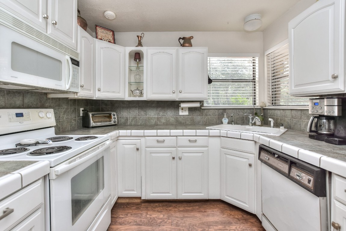 6724 Outer Avenue Leander, TX 78641 - Photo 19 of 40 a kitchen with cabinets appliances a sink and a window
