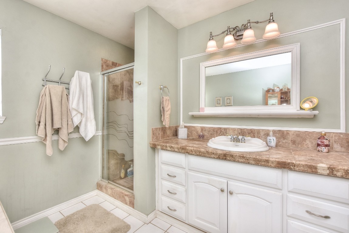 6724 Outer Avenue Leander, TX 78641 - Photo 26 of 40 a bathroom with a sink vanity granite and a mirror