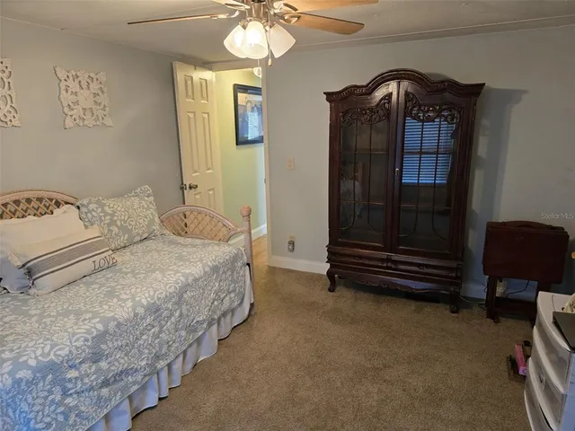 a bedroom with a bed and a dresser in it