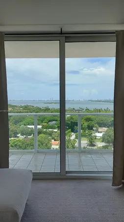a view of a glass door with a yard from a window