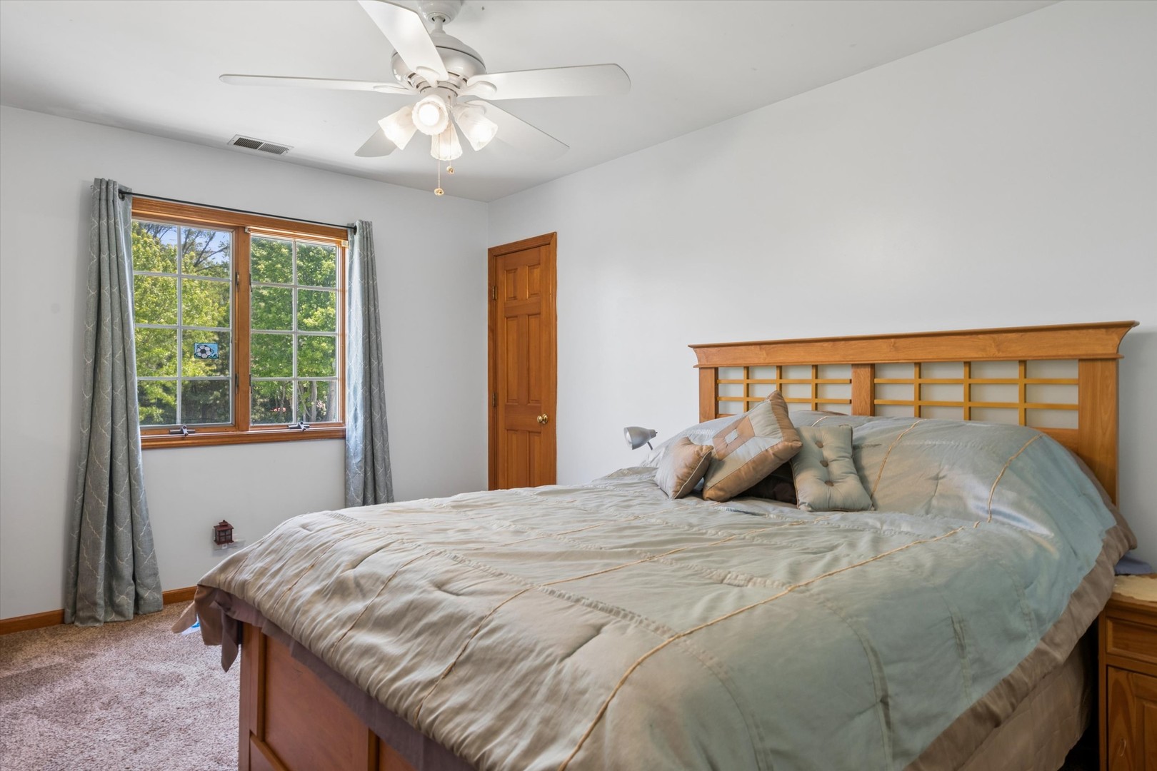 2142 North Summit Street Wheaton, IL 60187 - Photo 23 of 35 a bedroom with a large bed and a chandelier