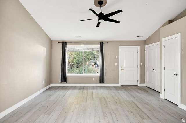 778 South 650 West Logan, UT 84321 - Photo 6 of 26 Spacious room featuring wood-finish flooring, a contemporary ceiling fan, and ample natural light from a large window
