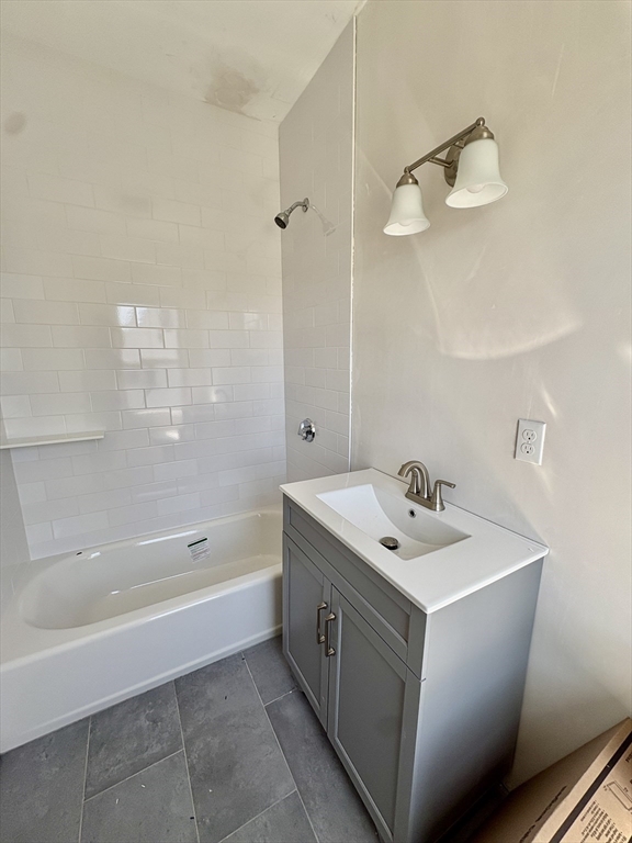 159 Parsons Street, Unit 2 Boston, MA 02135 - Photo 5 of 10 a bathroom with a sink a toilet and bathtub