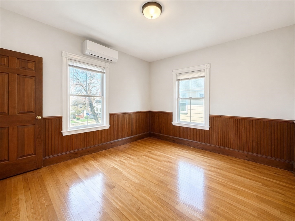 159 Parsons Street, Unit 2 Boston, MA 02135 - Photo 8 of 10 a view of an empty room with wooden floor and a window