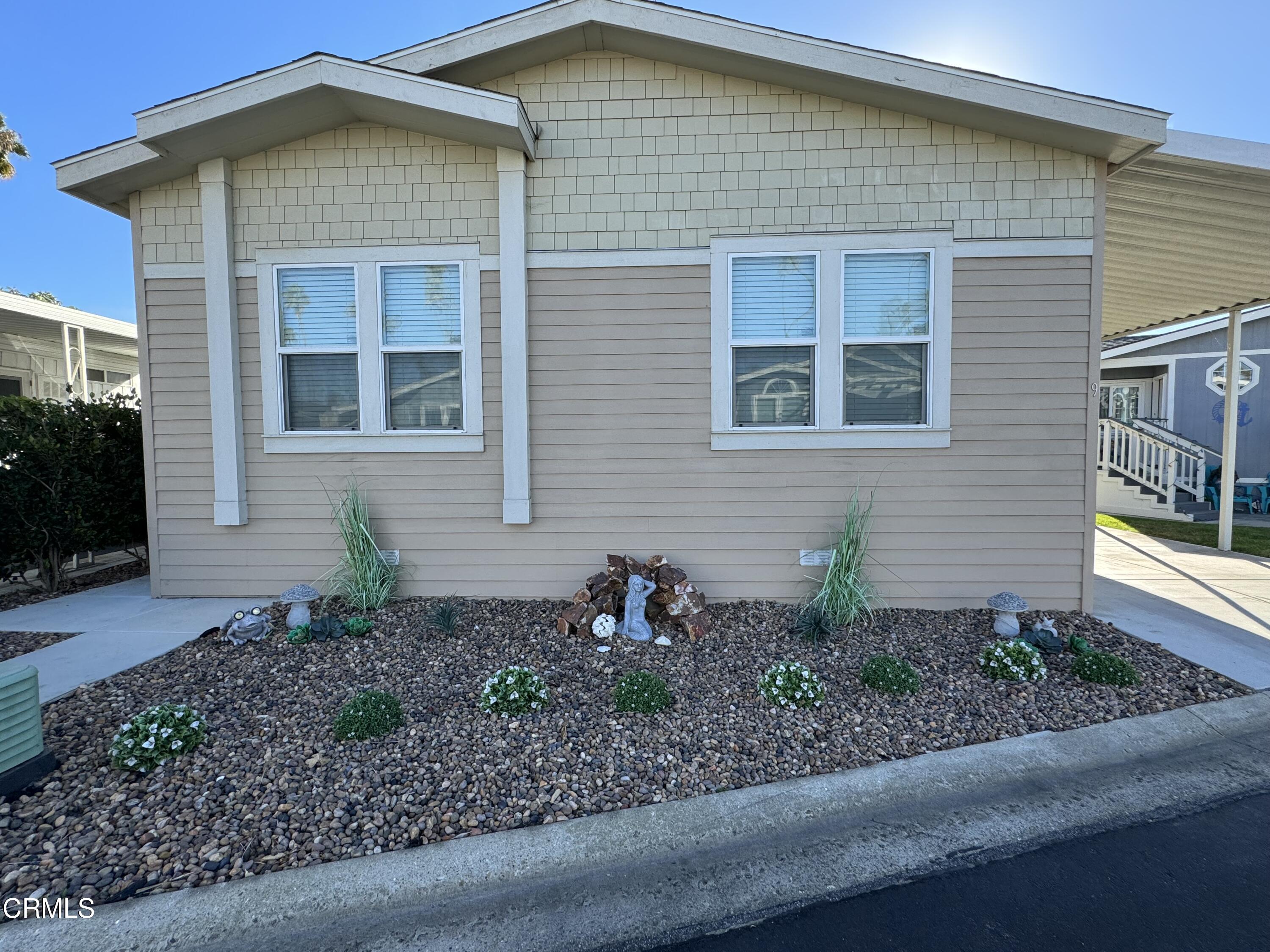 1215 Anchors Way Drive, Unit 9 Ventura, CA 93001 - Photo 1 of 52 a front view of a house with garden