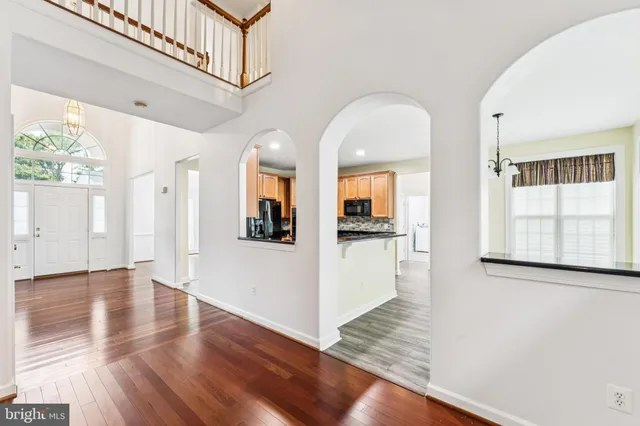 a view of an entryway with wooden floor fireplace and a window