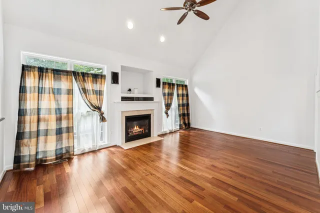 a living room with a fireplace and a floor to ceiling window