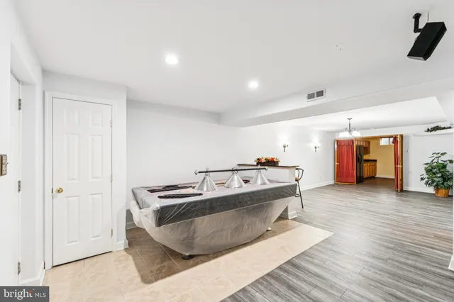 an empty room with a window and a ceiling fan