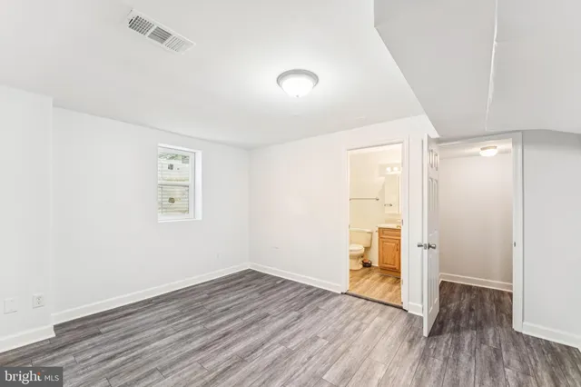 a utility room with wooden floor washer and dryer