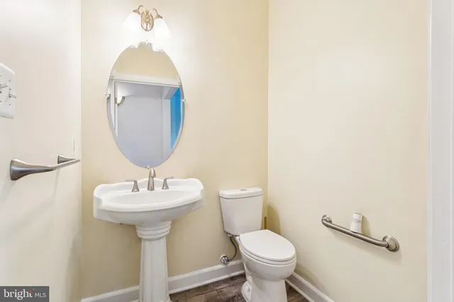 a view of a house with a yard and large trees