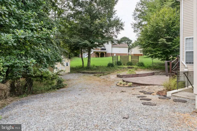 a view of a house with a yard and tree s