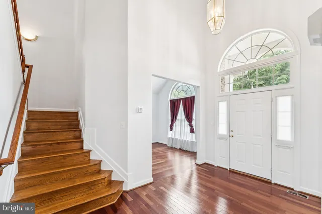 a view of staircase with railing and white walls