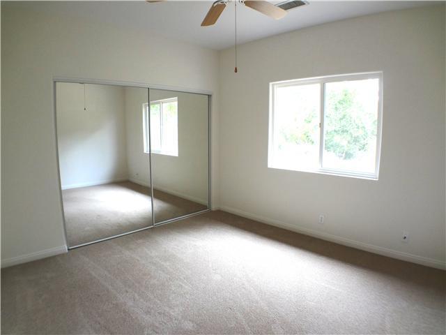 18263 Chablis Road Ramona, CA 92065 - Photo 15 of 25 This bedroom is located towards the back of the house. It includes a ceiling fan and mirrored closet doors.