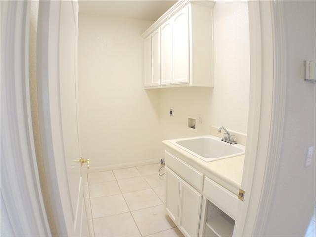 18263 Chablis Road Ramona, CA 92065 - Photo 17 of 25 The laundry room is centrally located in the hall way for easy access from all bedrooms. Plenty of storage with the built in cabinets and a full size sink.