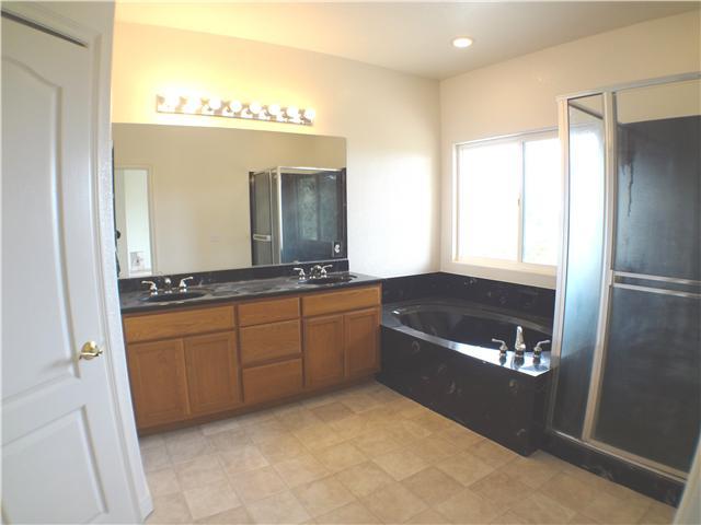 18263 Chablis Road Ramona, CA 92065 - Photo 20 of 25 Relaxation waiting to happen. The double sink vanity provides room to share. Enjoy the private view of the Ramona Valley while soaking in the sunken tub. The master bath includes a separate toilet closet for privacy and a very large walk in closet.