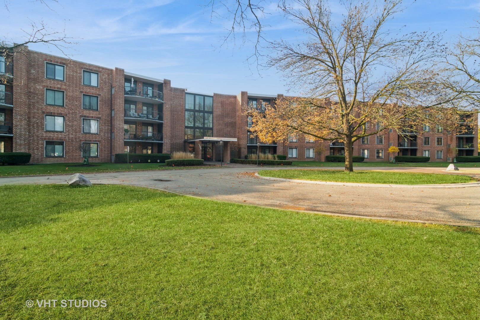 1505 East Central Road, Unit 111B Arlington Heights, IL 60005 - Photo 1 of 10 a view of a building with a yard