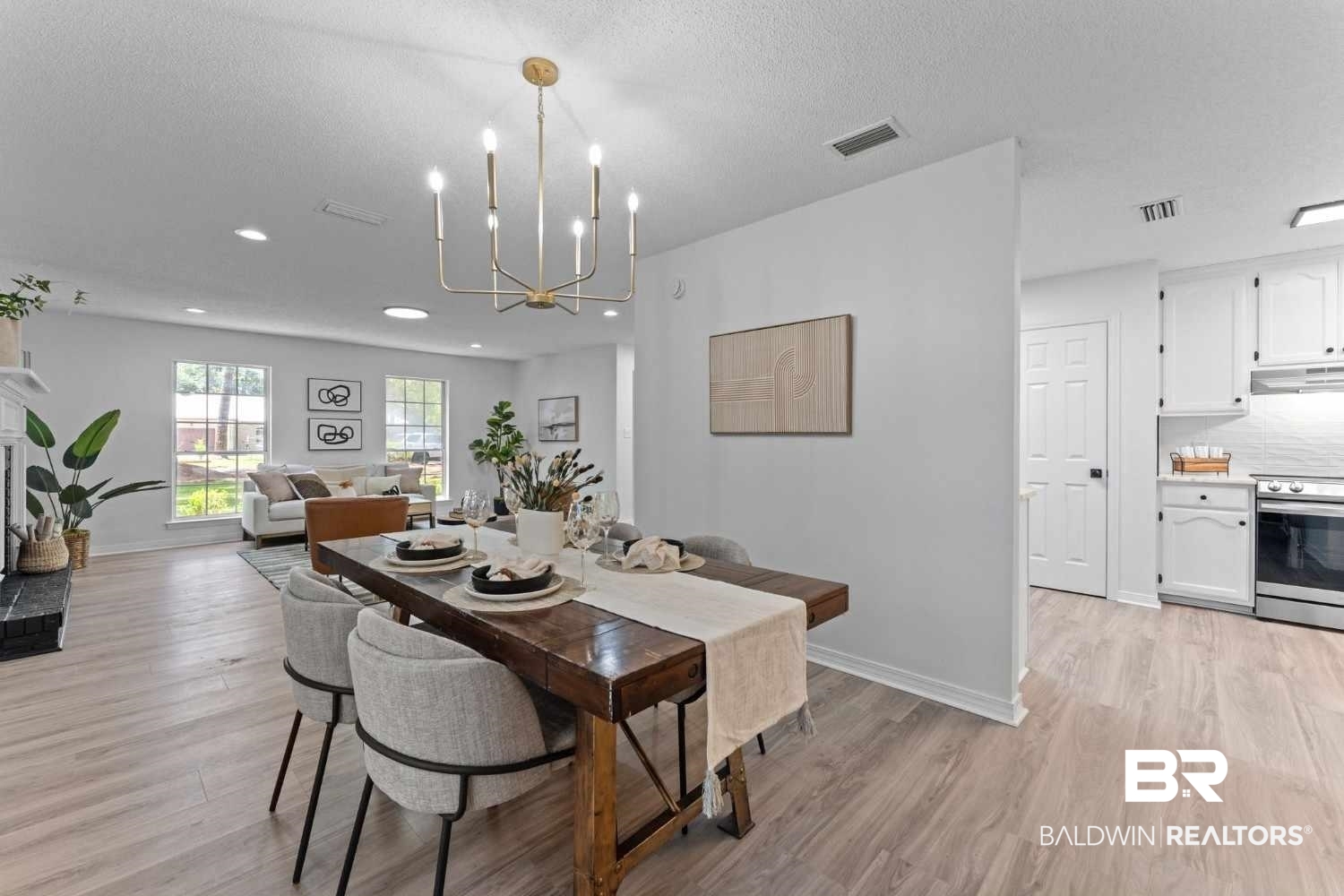 10251 Windmill Road Fairhope, AL 36532 - Photo 20 of 44 Dining area with a chandelier, light wood-style flooring, recessed lighting, and a textured ceiling