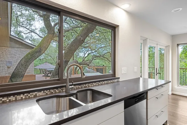 a kitchen with a sink and large window