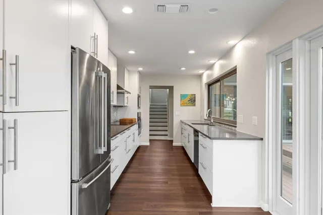 a kitchen with stainless steel appliances a refrigerator and a stove