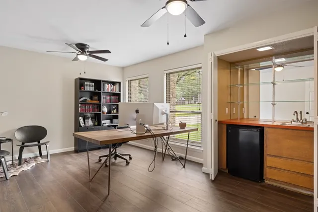 a view of a workspace with furniture and a window