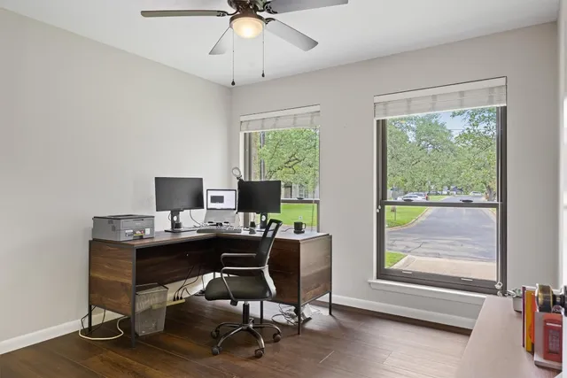 a view of a workspace with furniture and a window