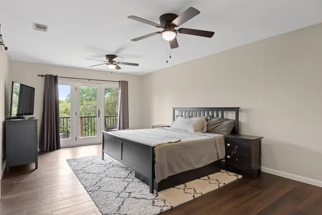a bedroom with a large bed and a chandelier