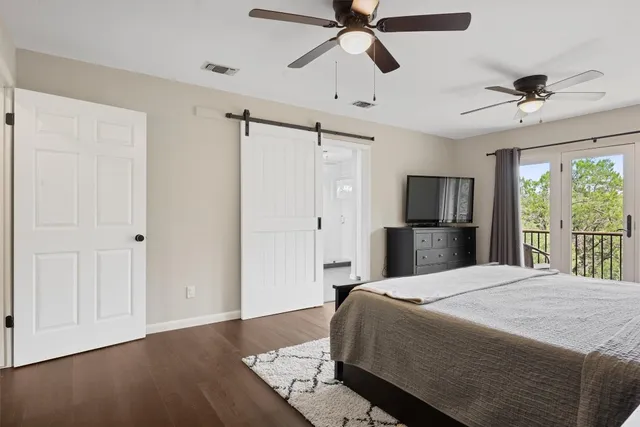 a bedroom with a large bed and a chandelier