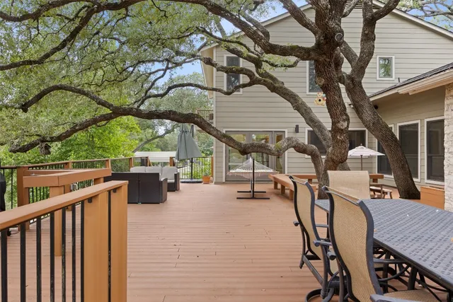 a view of a patio with a table chairs and a fire pit