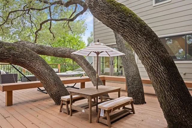 a view of backyard with outdoor seating and wooden fence